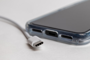 Fototapeta premium USB C Cable and new android phone charging cable on a studio white background close up macro shot screen protector 