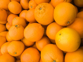 ripe but not very beautiful yellow-orange oranges of small size and on the counter of the supermarket