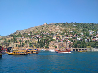 Fototapeta na wymiar summer, beach, sea, boat, mountains, fortress, ship in Turkey