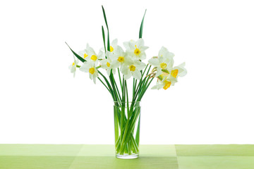 Bouquet of spring flowers of daffodils (narcissus) in a glass vase.
