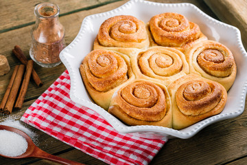 Sweet cinnamon rolls on a wooden table, homemade cakes