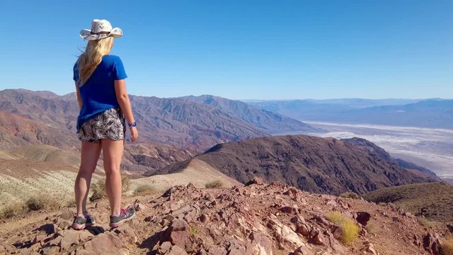 Sexy curvy woman admires the Landscape from the top of Dante's View in Death Valley National Park in California. It is one of the hottest places in the world. Gimbal panning cinematic ProRes 422 4K
