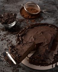 Raw chocolate cheesecake on dark grey background. Healthy organic dessert pie. Cacao and chocolate...