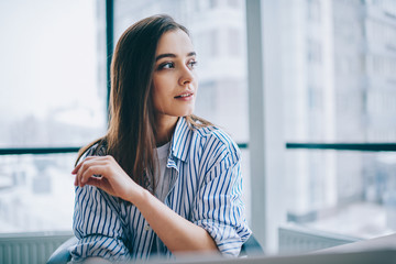 Dreamy lady looking away in office