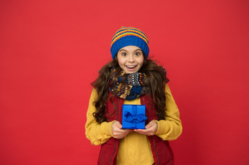 oh my god. girl knitted hat and scarf. ready for christmas. she is going on xmas party. seasonal shopping sales. childhood happiness. winter girl with new year present box. happy winter holidays