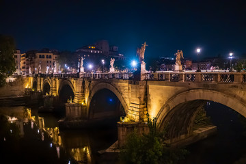 Saint Angelo Bridge over Tiber River in Rome at night, Italy.