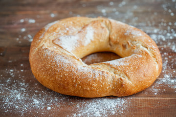 traditional Galician white round bread with a hole on wooden background.