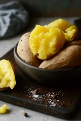 Boiled Potatoes in a peel in a bowl with spices, herbs, herbs. Lunch, the main side dish for dinner, with sour cream.