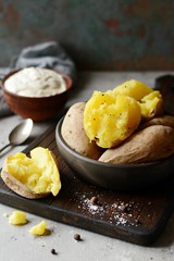 Boiled Potatoes in a peel in a bowl with spices, herbs, herbs. Lunch, the main side dish for dinner, with sour cream.