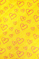 Heart pattern on a gold background with shiny glitter. Love concept.