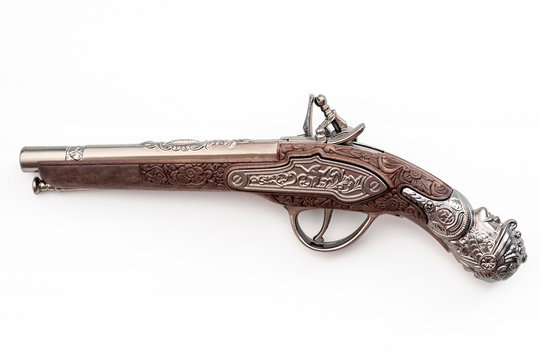 Firearms dating to the american revolution and antique collectables concept with ornate old fashioned dueling flintlock pistol isolated on white background with clipping path cutout