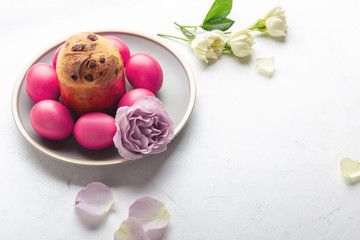 Easter cake, natural dyed Easter eggs and flowers on festive table