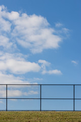 a fence on a blue sky