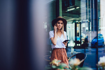 Stylish woman listening to music in cafe