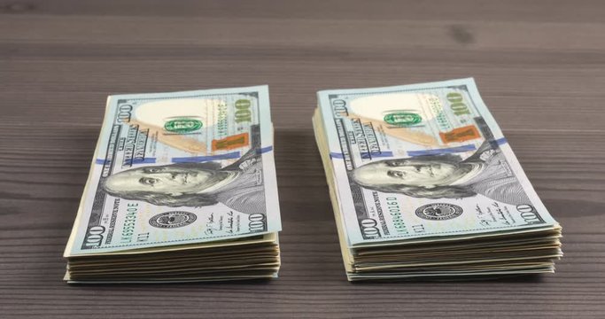 Stop motion footage with pack of one hundred american dollars moving from left to right, cash money is a concept of business, finance and capital movement