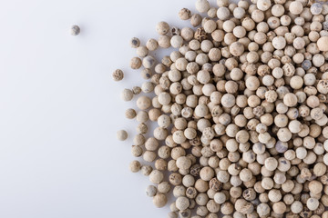 white peppercorns seed on white acrylic background