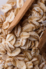 raw oat flakes on white acrylic background