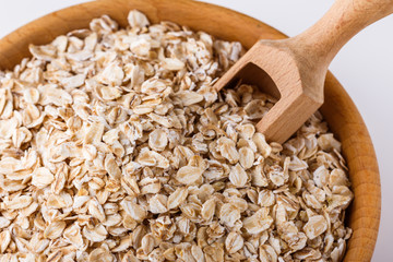 raw oat flakes on white acrylic background