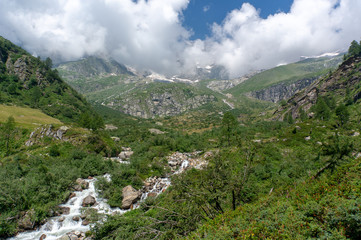 Fototapeta na wymiar Hiking for health in Italian alps landscape