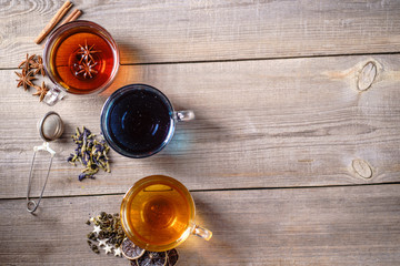 Collection of brewed green, cinnamon anise spiced and blue anchan tea in glass mugs. Tea shop and cafes