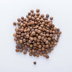 fresh spicy peppers allspice on white acrylic background