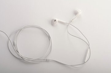 White headphones with headset lie on white isolated background.
