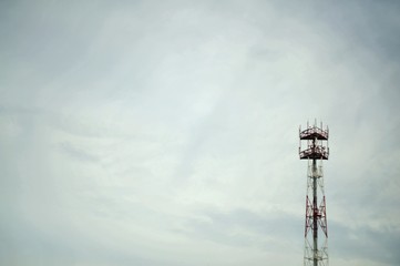 Obraz premium iron red-white tower on a background of gray sky cop