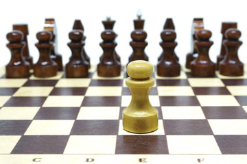 Chess, lone white pawn against enemies. Shallow DOF, focus on white pawn. Isolated on white.