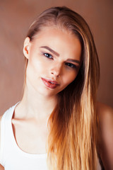 Naklejka premium young pretty blond woman with fresh natural makeup posing cheerful on browm background, lifestyle people concept