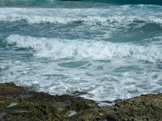 Fototapeta na wymiar Waves Crashing into Rocks on Coast of Cozumel, Mexico