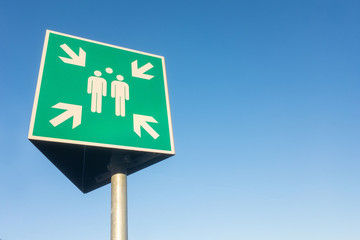 outdoor sign in Germany for a meeting point isolated against the sky.