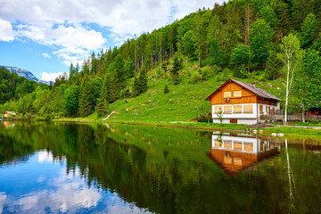 Fototapeta na wymiar Traditional mountain house in Austrian Alps near of lake Sommersberg