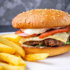traditional american burger on a gray stone background