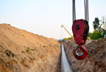Natural gas pipeline construction work. A dug trench in the ground for the installation and...
