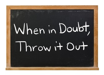 Obraz premium When in doubt, throw it out written in white chalk on a black chalkboard isolated on white