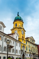Fototapeta na wymiar Yellow City Clock Tower in the center of Rijeka, Croatia