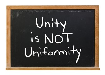 Obraz premium Unity is not uniformity written in white chalk on a black chalkboard isolated on white