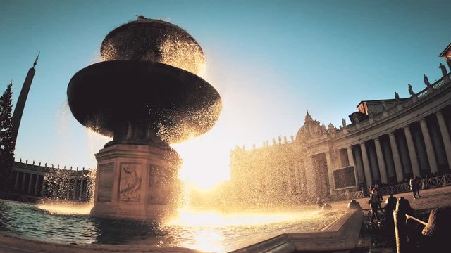Silhouette of the fountain on the Saint Peter square outside the vatican at sunset. Slow motion