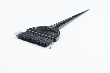 Old black hair dye brush isolated on white background. Copy space.