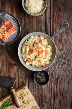 Kapustove halusky known as Strapacky, classic dish in Slovakia, boiled potato dumplings with sauerkraut and onion, topped with fried bacon and fresh chives