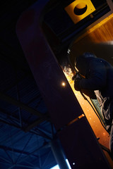 Fototapeta na wymiar welder working with electrode at semi-automatic arc welding in manufacture production plant.Selective focus