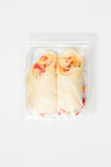 Use less plastic! Two wraps in plastic packaging isolated on white ground. Symbol for environmental pollution done by the food industry