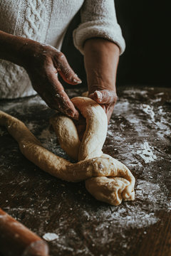 A Woman Prepares Homemade Braided Bread at Home