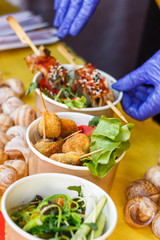 snails at the counter of the street food festival