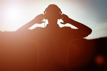 stylish bearded man in headphones listening to music