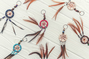 Ethnic dreamcatchers on a wooden background. Dream catchers, indian amulet, feathers, decoration.