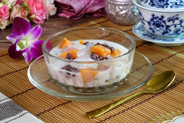 Dubo or Tubo, famous Phuket dessert. Made by cooking sweet potatoes, taro, red beans and droplets of tapioca flour in coconut milk with sugar palm syrup. Selective focus