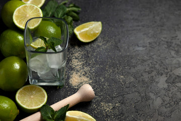 process of making homemade cocktail, flat with the ingredients for mojito on a black background, a refreshing summer cocktail