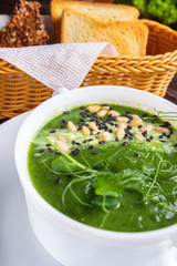 broccoli spinach cream soup on rustic wooden background