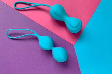 Sex toys. Two jiggle balls on a color background. Blue ben wa balls. Useful for adult, sex shop
